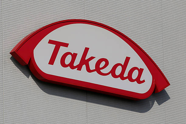 The Takeda Pharmaceutical Co. logo is displayed at it's Shonan Research Center in Fujisawa, Kanagawa Prefecture, Japan, on Tuesday, Dec. 15, 2015. With about 1.78 trillion yen ($15 billion) in annual revenue, Takeda ranks 18th among the 20 largest pharma companies worldwide. Photographer: Yuriko Nakao/Bloomberg via Getty Images